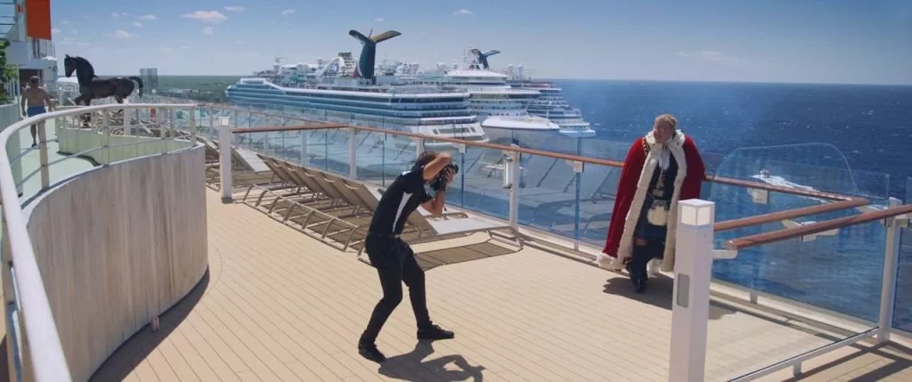 a man standing on the edge of the cruise in a cape